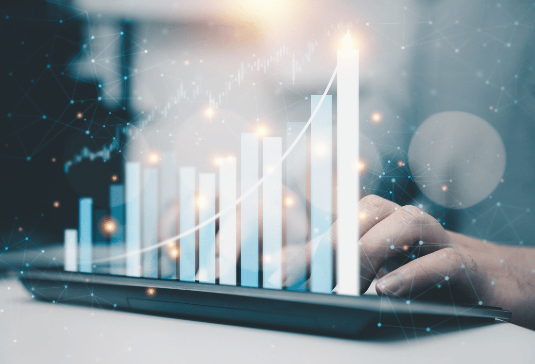 A person typing with a graph showing how cleansing data unlocks B2B financial services business growth.  